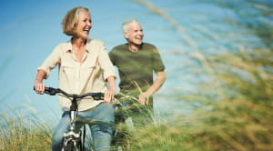 Retirement planning tips elderly couple riding bikes